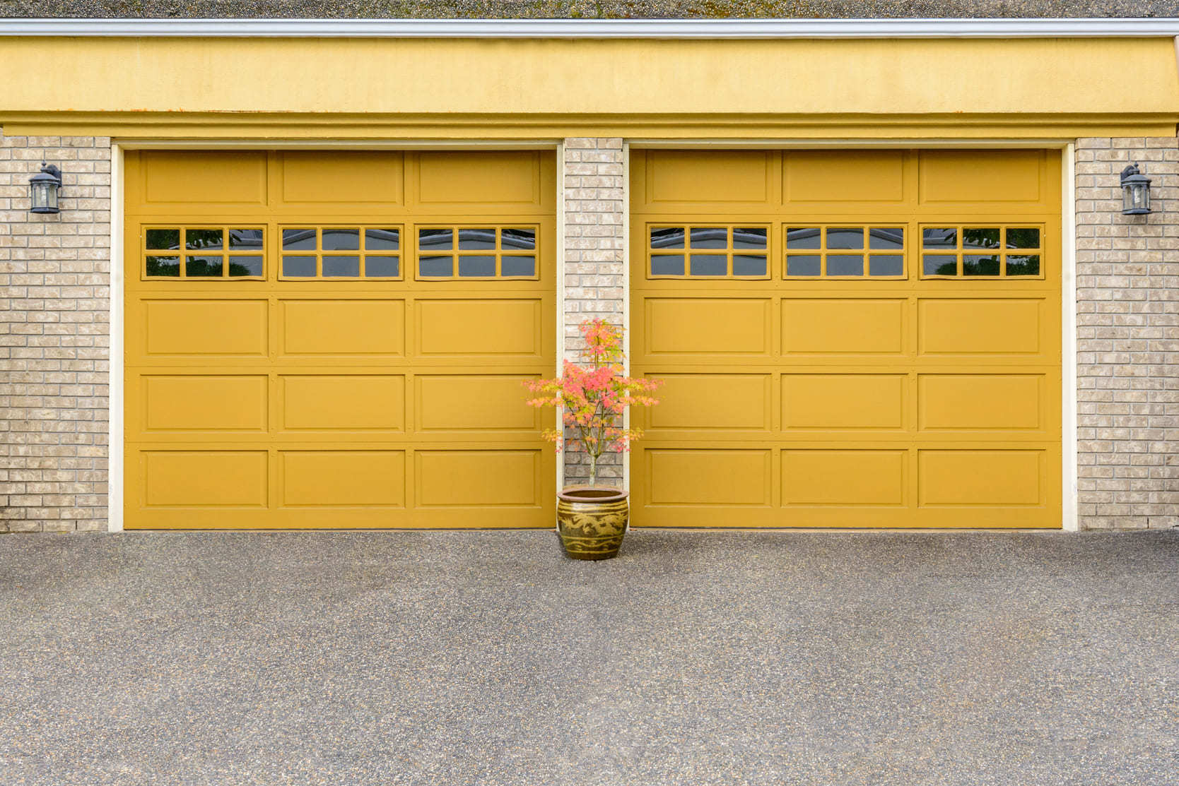 Yellow garage doors of a family home typical of homes for sale in Brooklin, Ontario